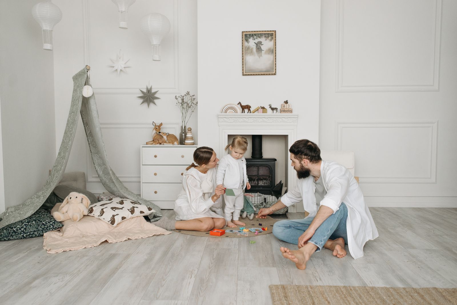 A host family playing together with their young child at home
