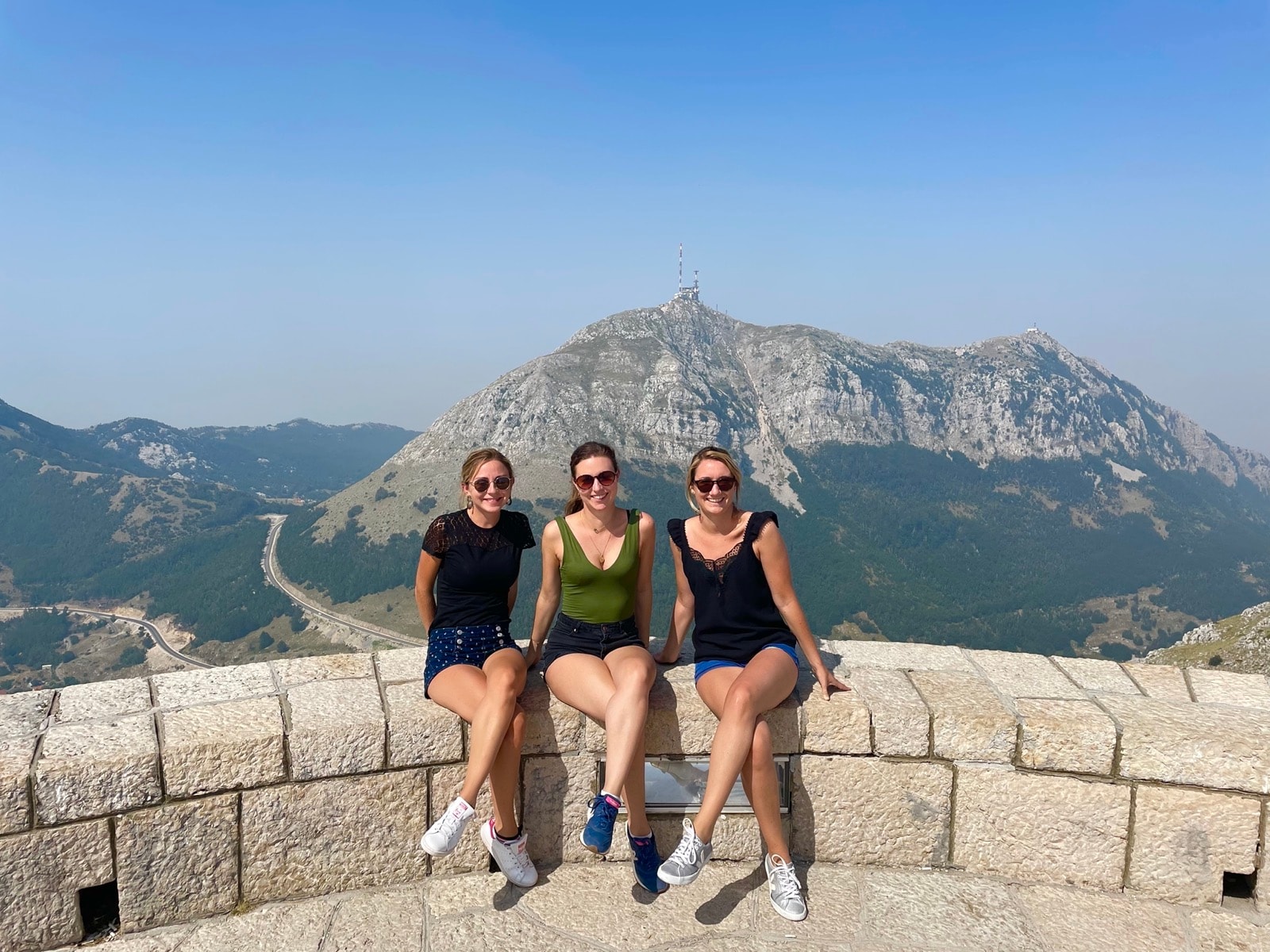 Three au pairs together at a mountain viewpoint